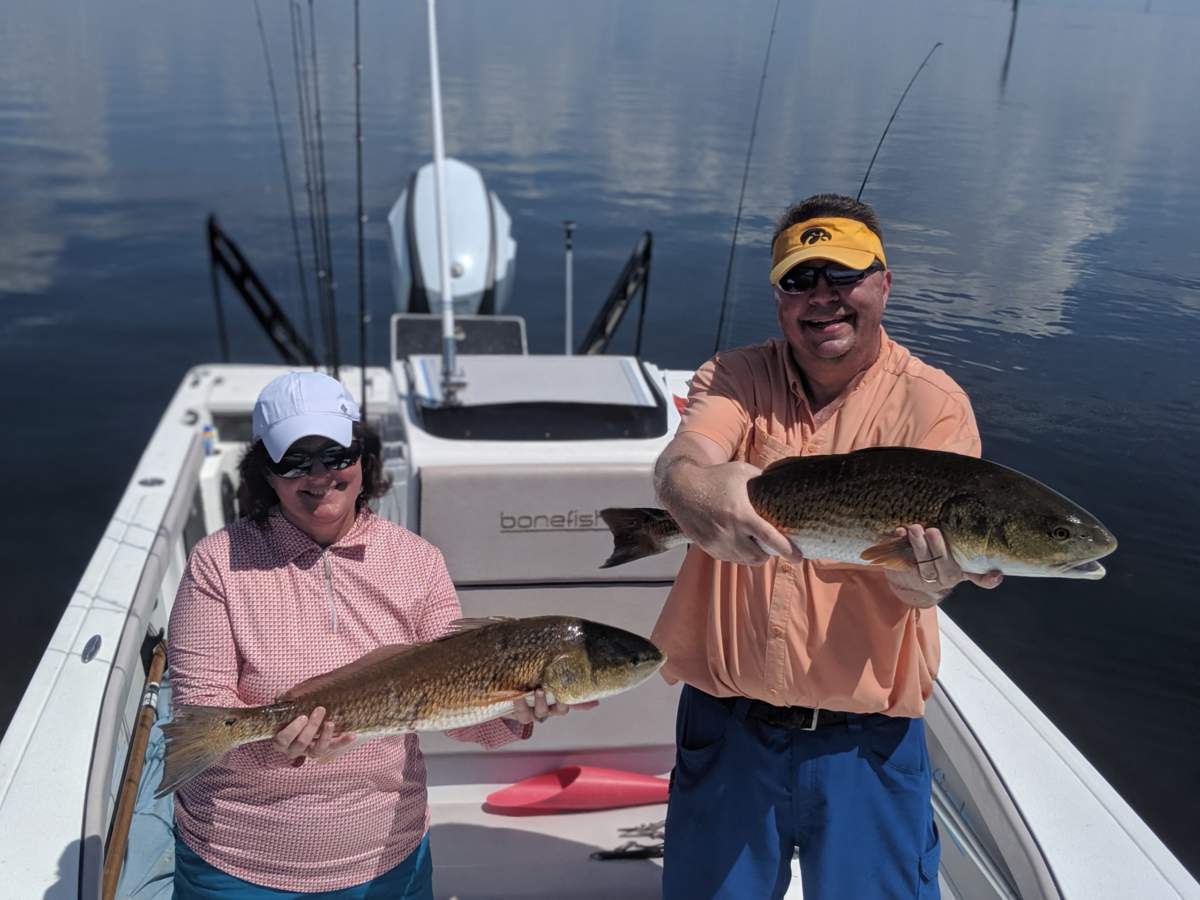 Jon and Melissa with two Tampa Bay redfish